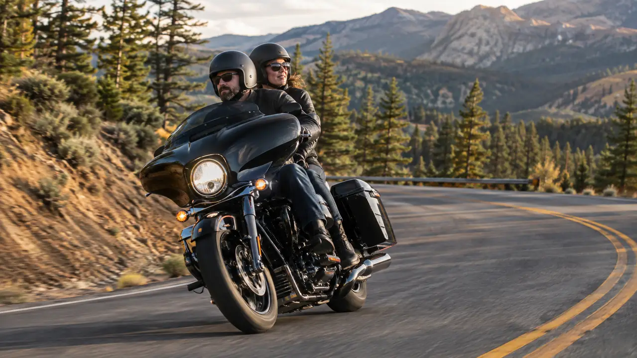 A touring motorcycle with rider and passenger leaning through a curve on a mountain highway
